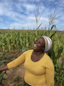 Smallholder farmer in South Africa shows her field of maize